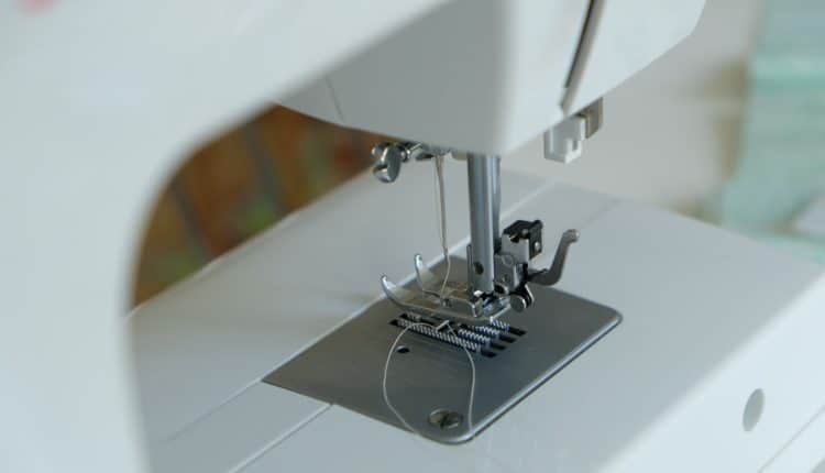 white sewing machine on table