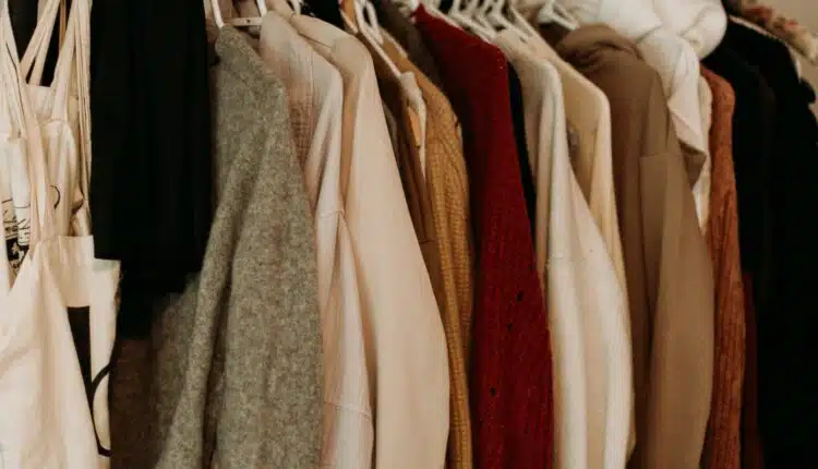 brown and white coat hanged on rack