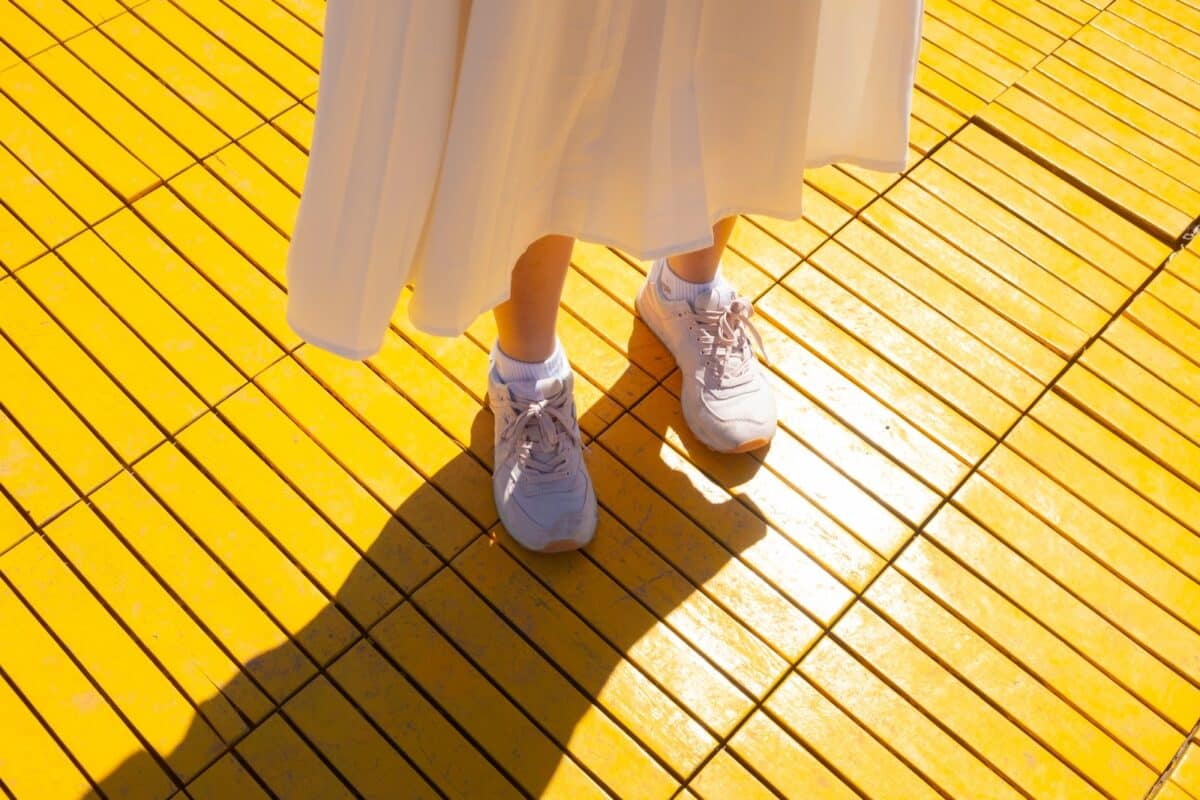a person standing on a yellow tiled floor